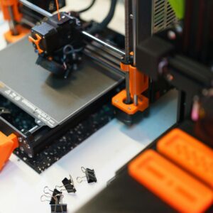 Detailed view of a 3D printer in a modern industrial setting, showcasing technology and creativity.